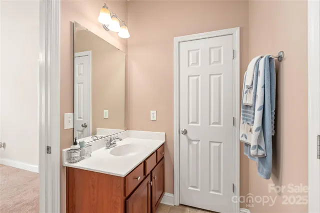 a bathroom with a sink vanity and a mirror