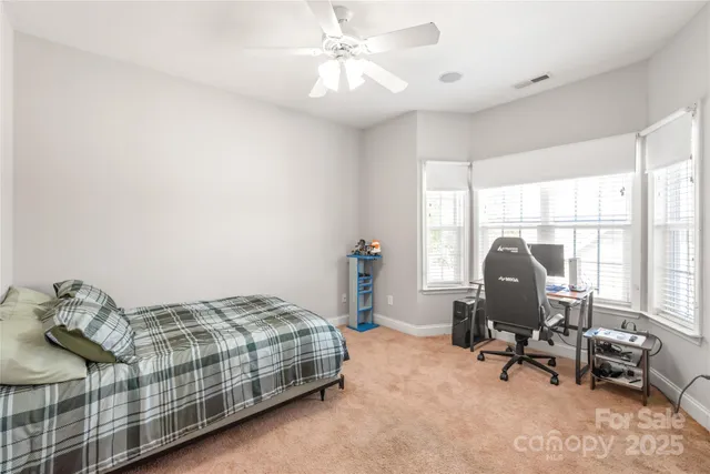 a bedroom with bed and a window