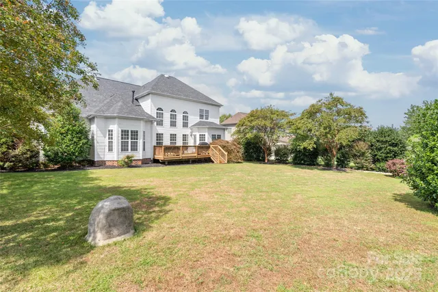 a view of a house with a yard and sitting area