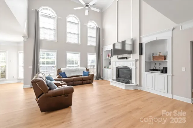a living room with furniture a fireplace and a flat screen tv