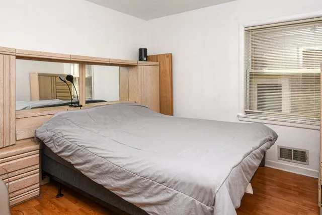 a bed sitting in a bedroom next to a window