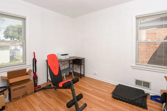 a view of a workspace with furniture and a window