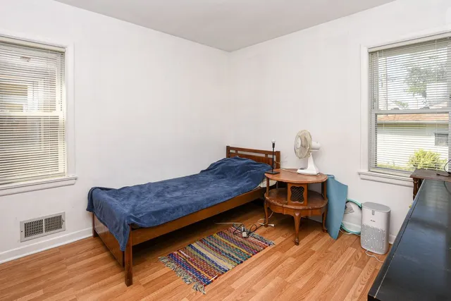 a living room with a bed furniture and a window