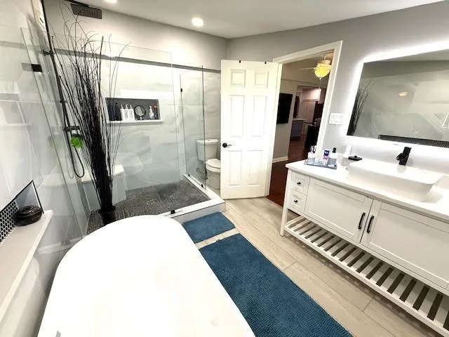 a bathroom with a sink toilet and shower