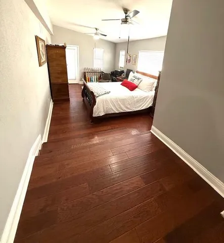 a bathroom with a sink a toilet a mirror and shower