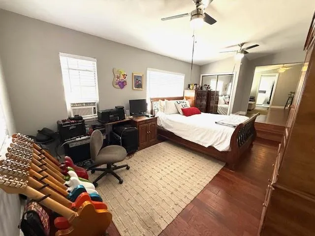 a bedroom with furniture and wooden floor