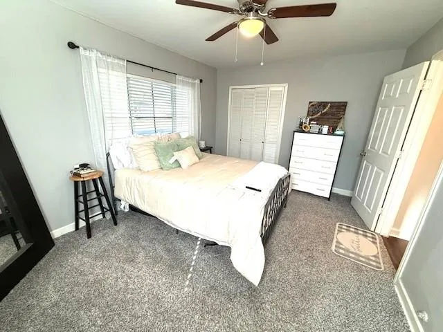 a spacious bedroom with a bed and a window