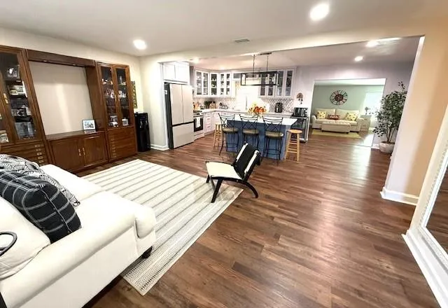 a living room with furniture and a wooden floor