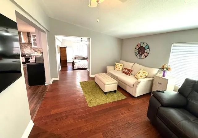 a living room with furniture and a wooden floor