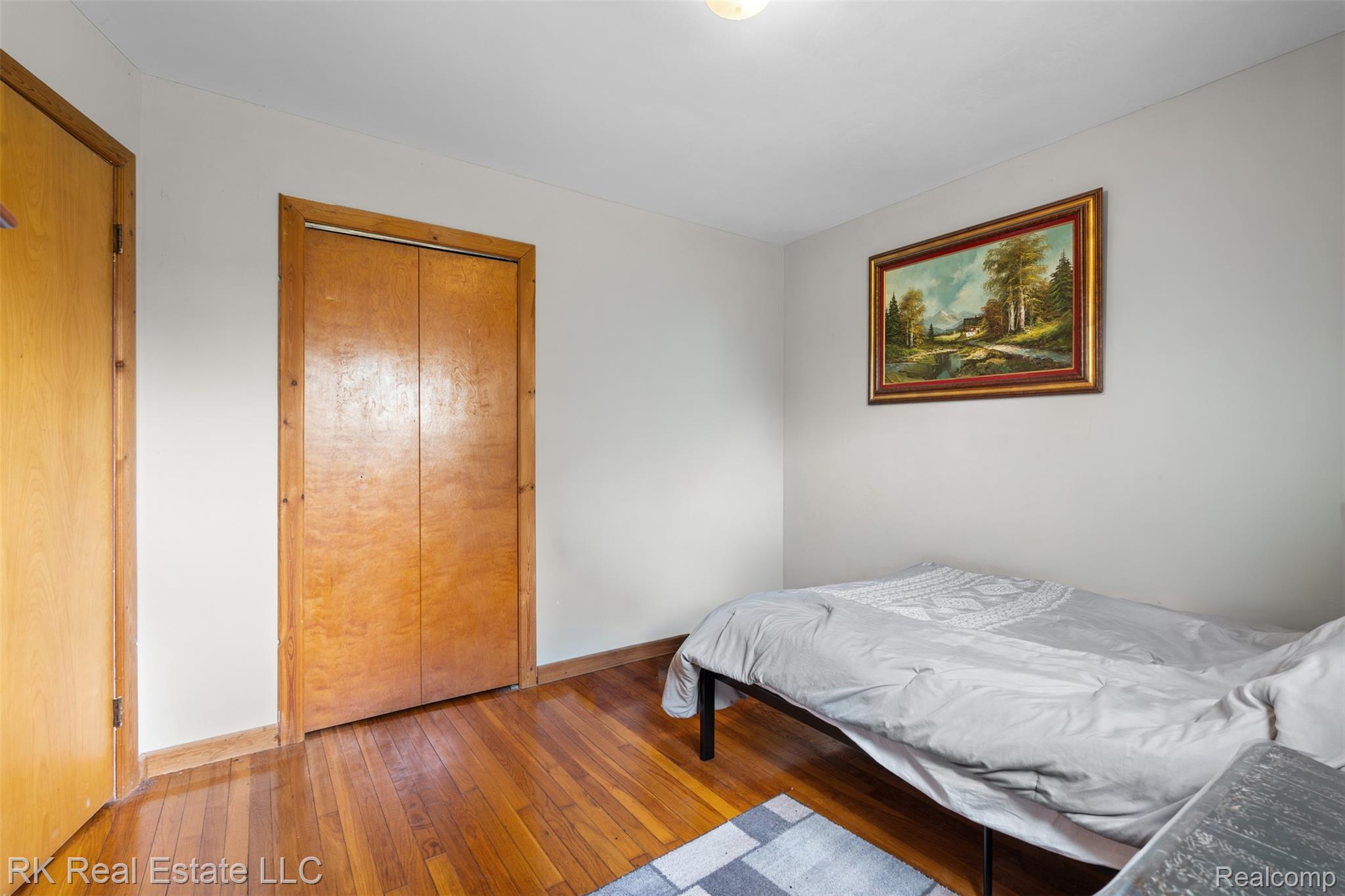 13799 31 Mile Road Washington, MI 48095 - Photo 23 of 40 Bedroom with wood-type flooring and a closet