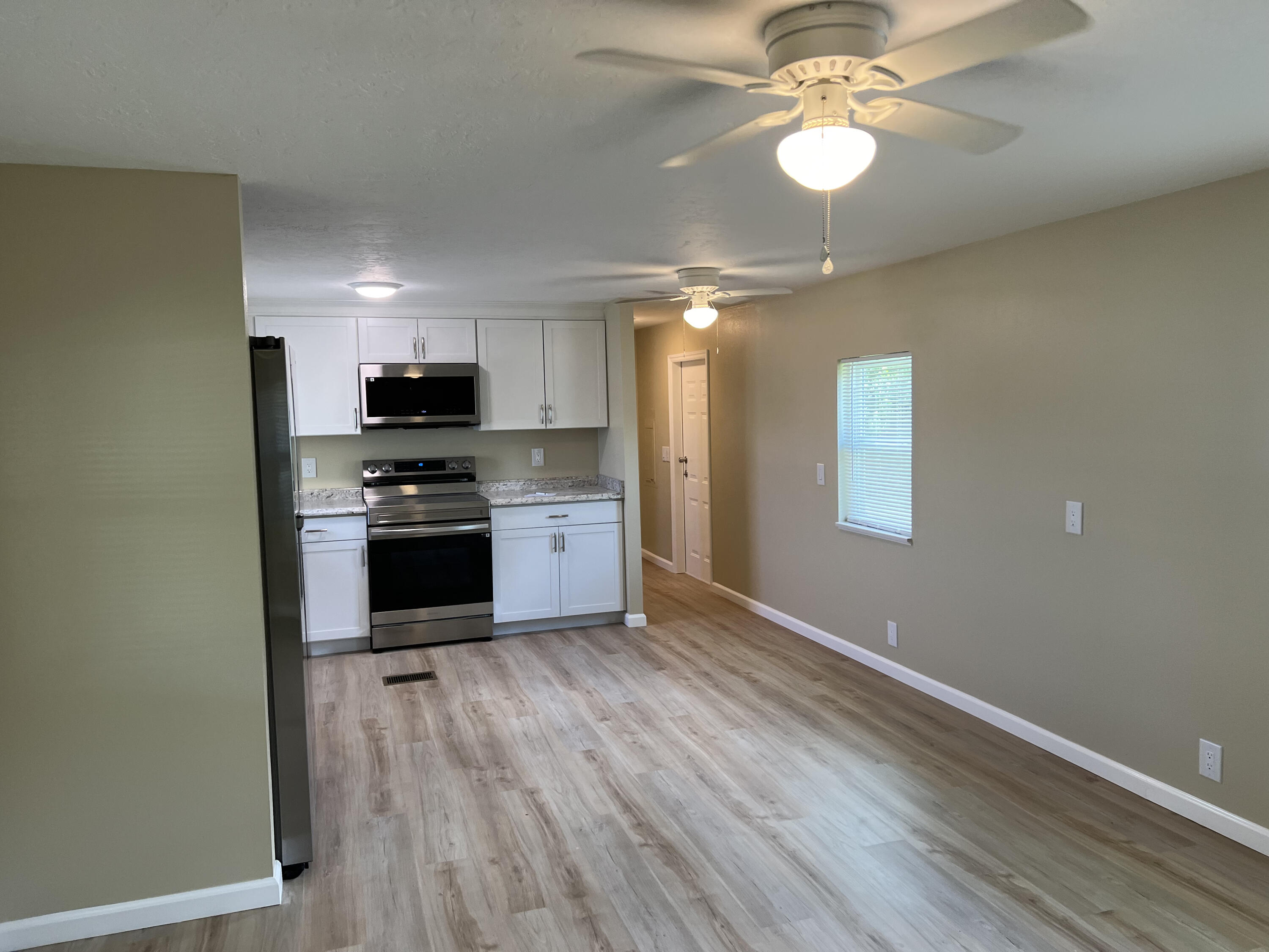 1065 Moonlight Court Palm Bay, FL 32907 - Photo 4 of 11 a kitchen with stainless steel appliances granite countertop a stove top oven a sink and dishwasher
