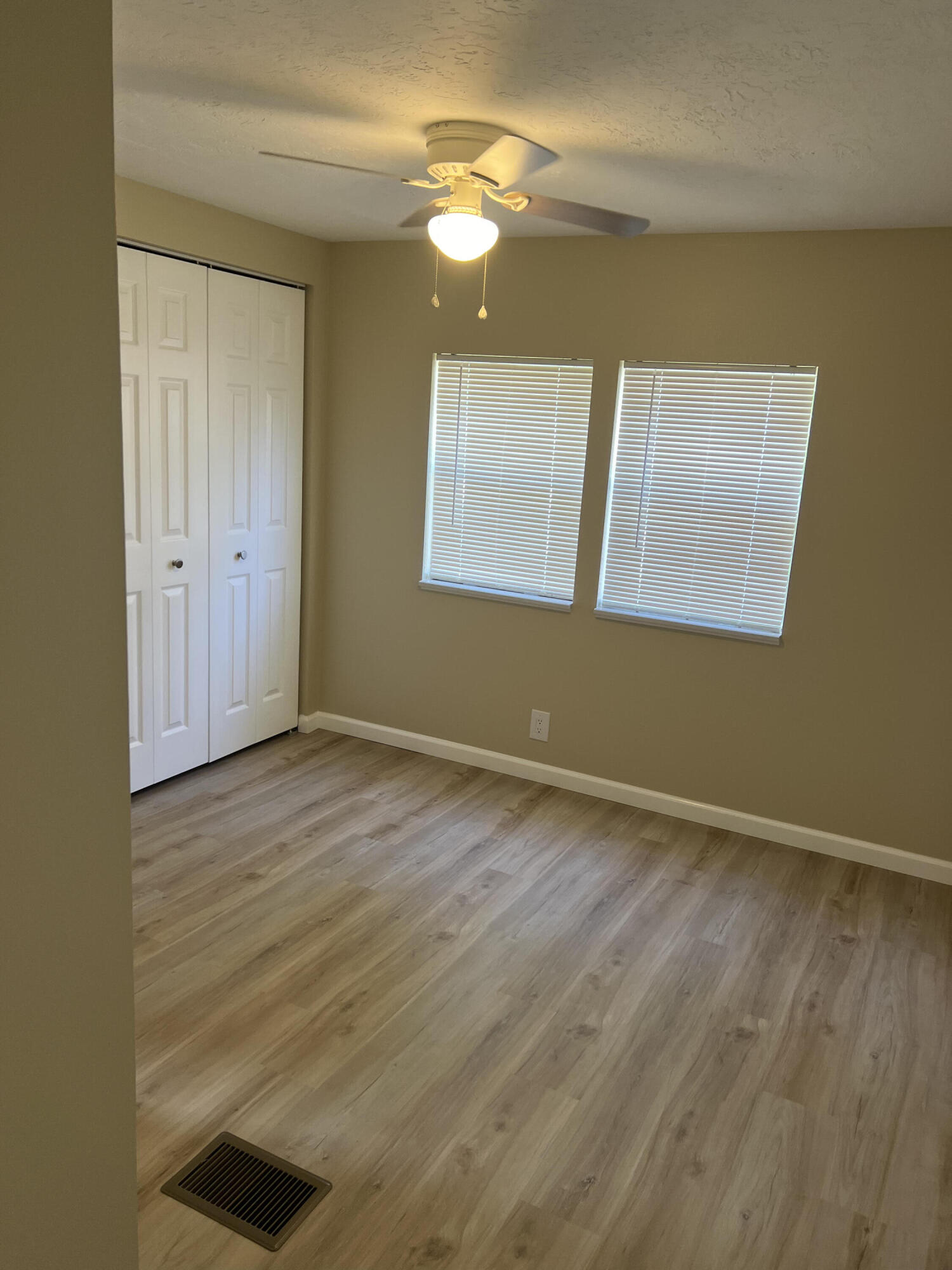 1065 Moonlight Court Palm Bay, FL 32907 - Photo 5 of 11 a view of an empty room with window and wooden floor