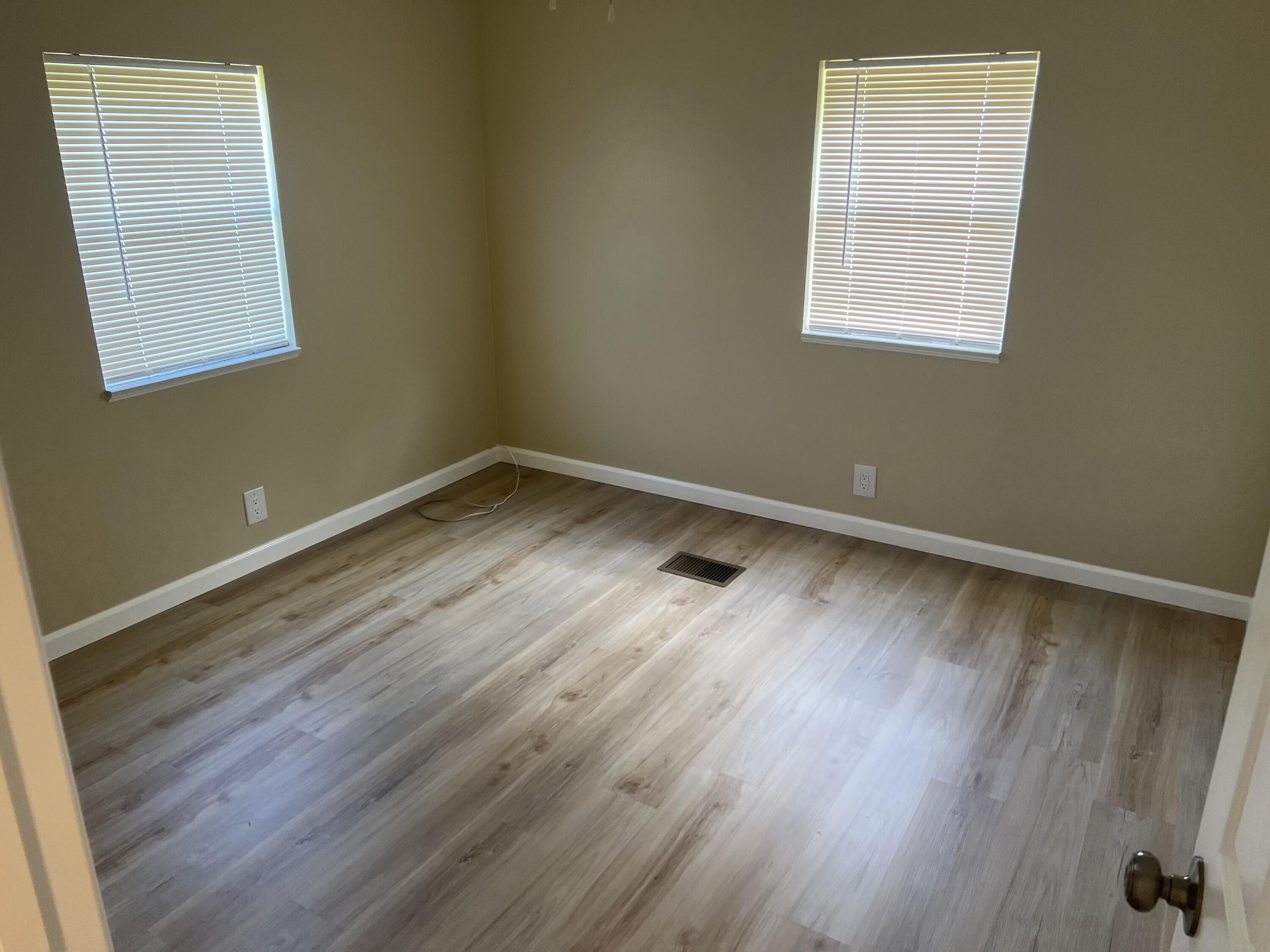 1065 Moonlight Court Palm Bay, FL 32907 - Photo 10 of 11 an empty room with wooden floor and windows