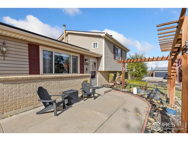 a view of a patio with a table and chairs