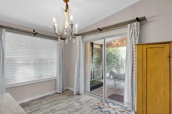 a view of a hallway with a chandelier and glass door