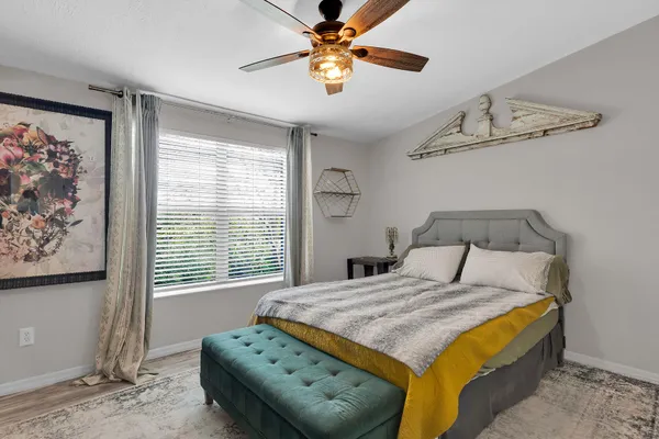 a bedroom with a bed and a chandelier