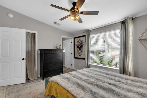 a bedroom with a bed and a chandelier