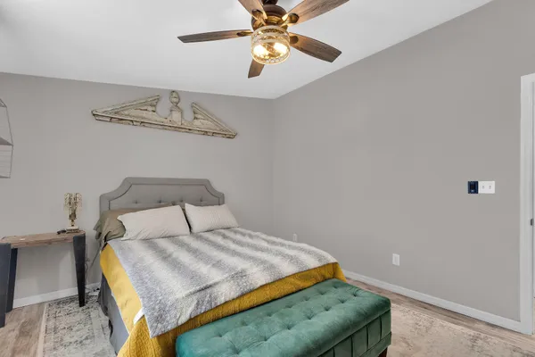 a bedroom with a bed and a chandelier