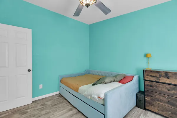 a bedroom with a bed and a ceiling fan