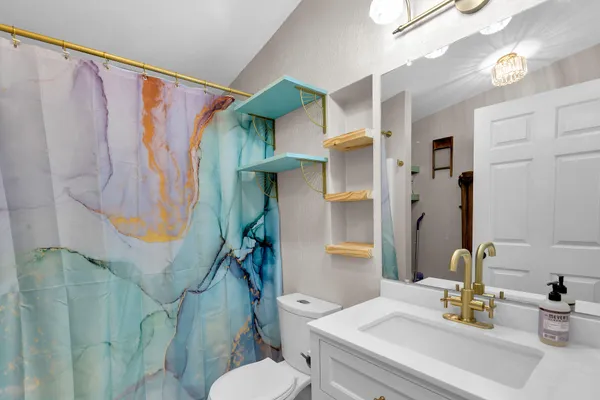 a bathroom with a sink toilet and shower