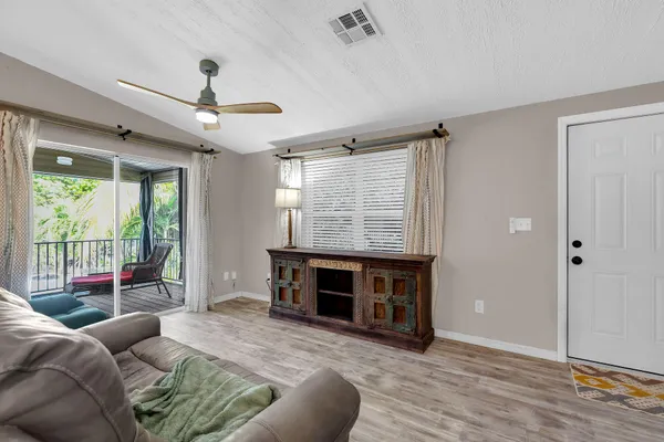 a living room with furniture a window and a fireplace