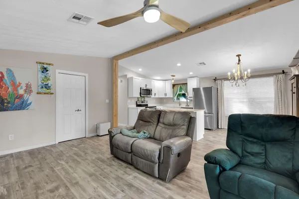 a living room with furniture and kitchen view