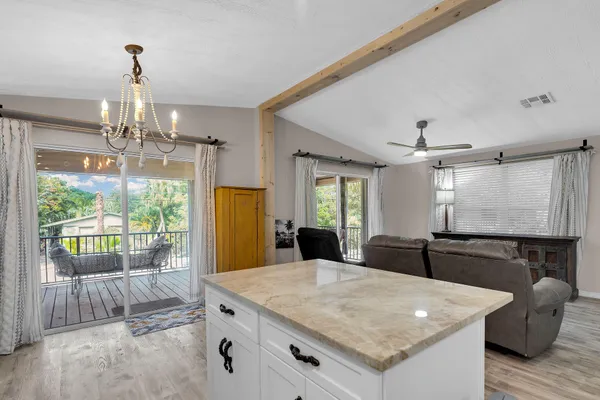 a kitchen with granite countertop a stove and a refrigerator