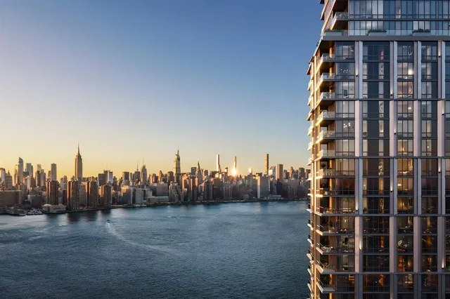 a view of a lake with a city skyline in the background