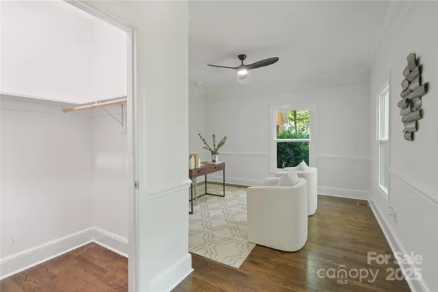 a living room with furniture a chandelier and a fireplace