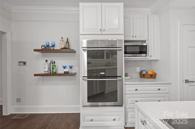 a utility room with wooden floor washer and dryer