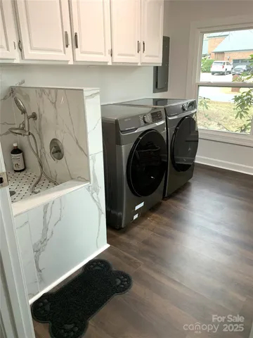 a bathroom with a granite countertop sink a large mirror and a window