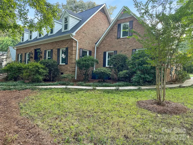 a front view of a house with garden and porch