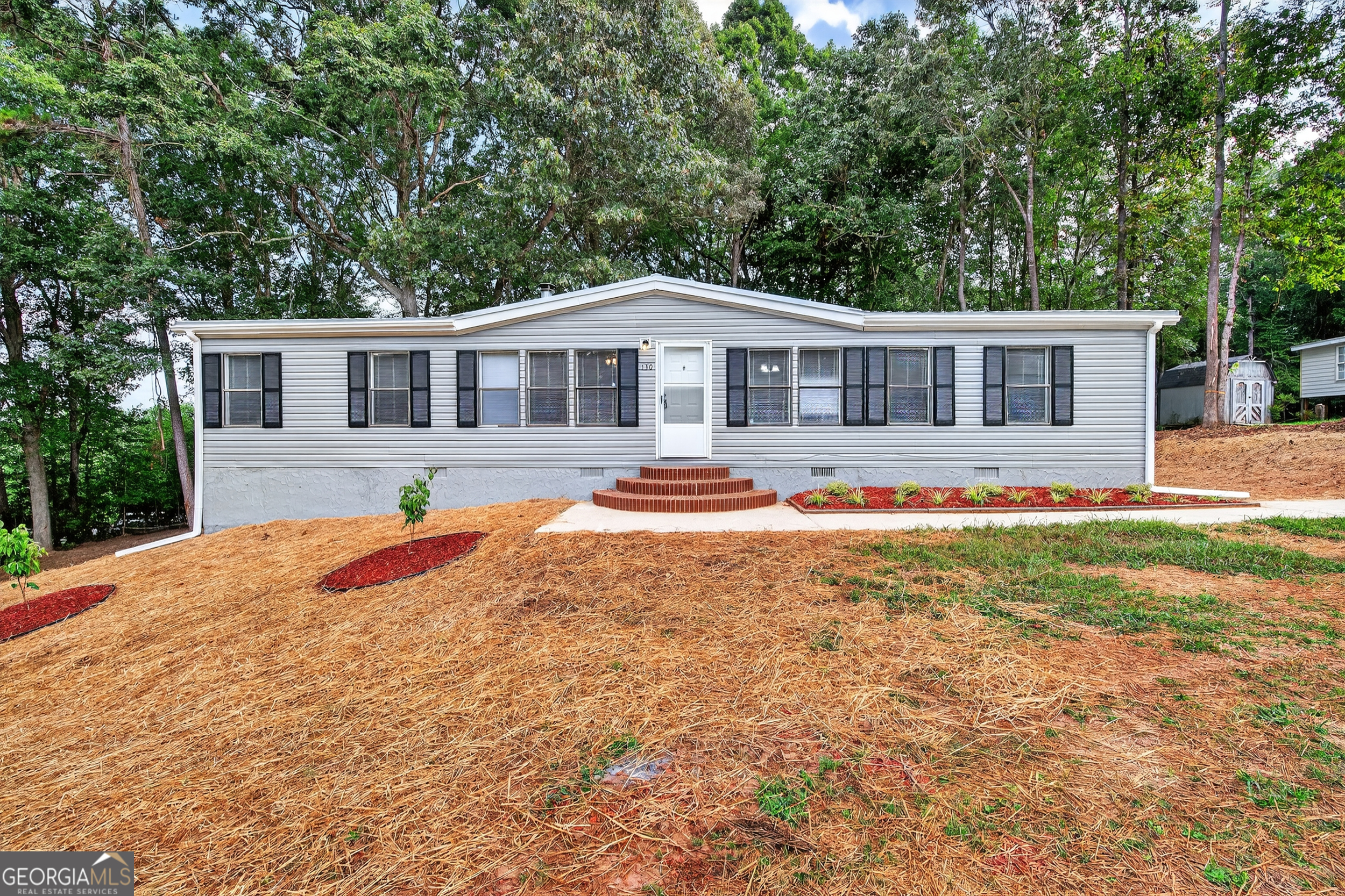 130 Winding Vine Lane Nicholson, GA 30565 - Photo 1 of 1 a front view of house with yard and trees around