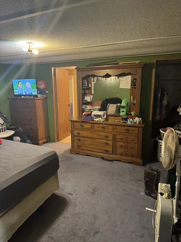 a bedroom with a bed and a mirror