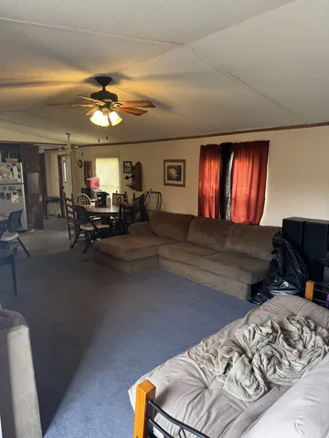 a view of a livingroom with furniture and chandelier