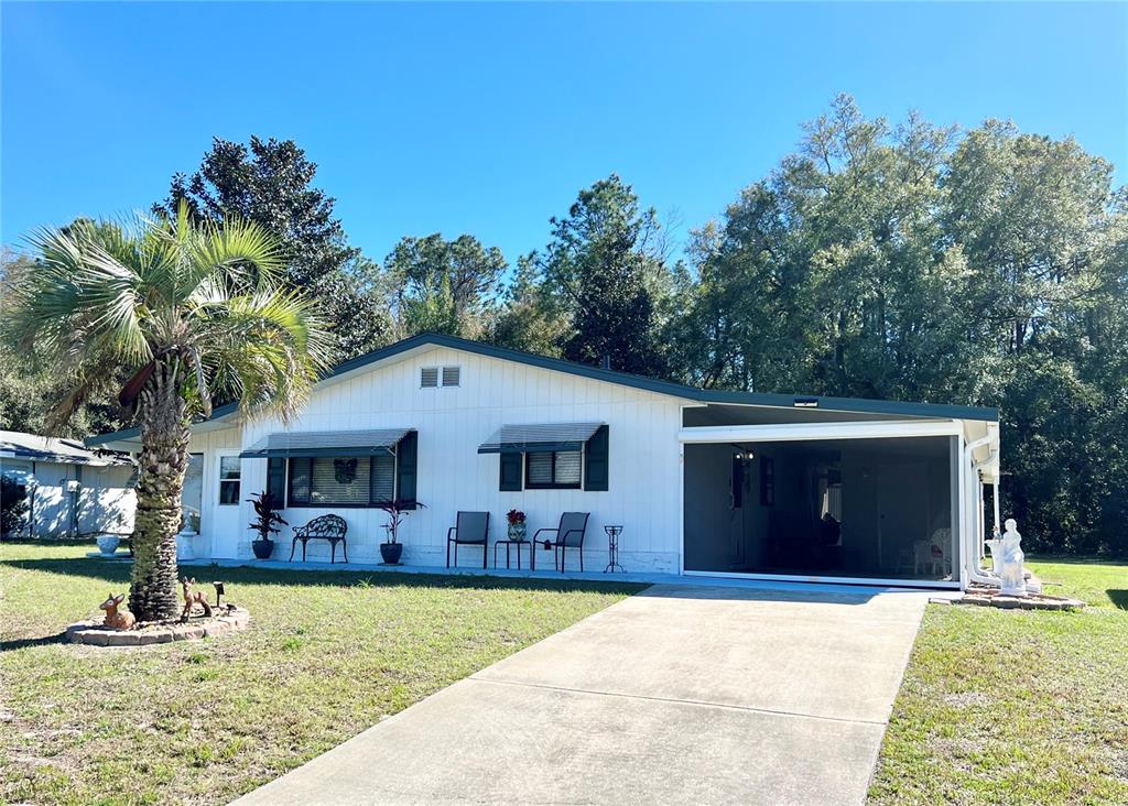 9480 Southwest 102nd Place Ocala, FL 34481 - Photo 1 of 1 a front view of a house with garden