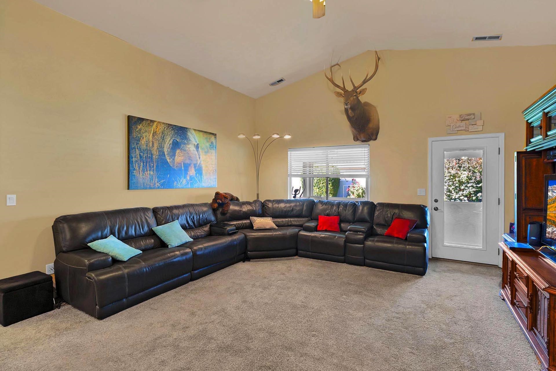 247 Mason Ridge Drive Grand Junction, CO 81503 - Photo 15 of 40 a living room with furniture and a flat screen tv