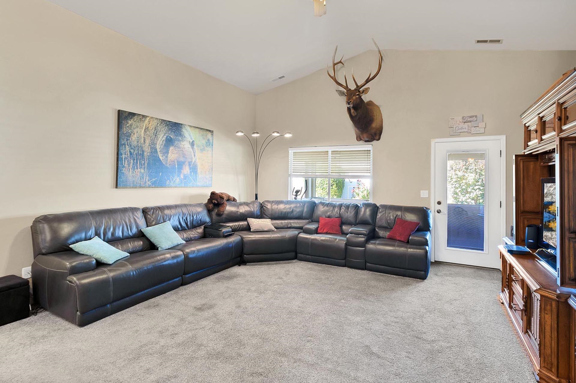 247 Mason Ridge Drive Grand Junction, CO 81503 - Photo 17 of 40 a living room with furniture and a flat screen tv