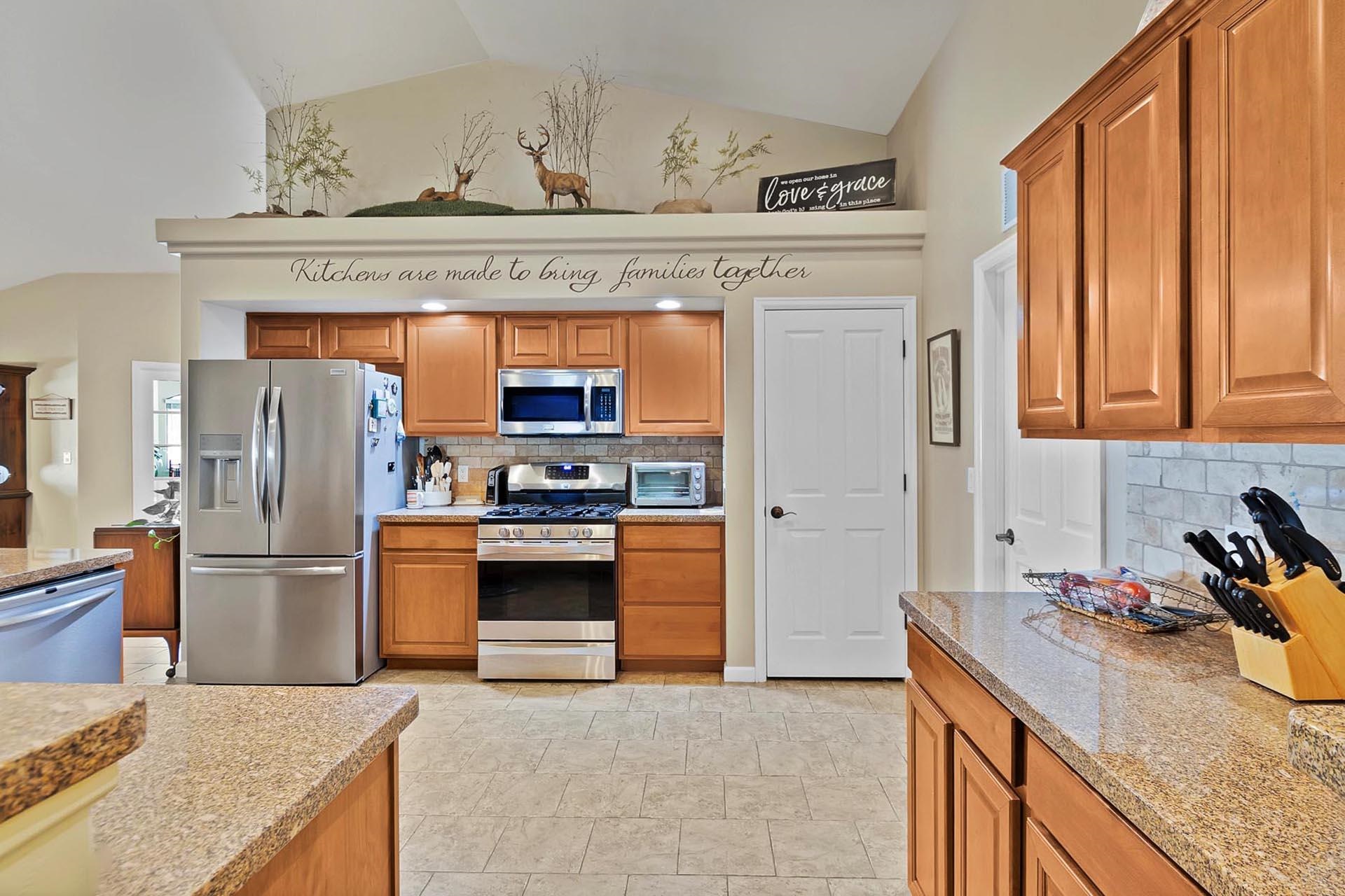 247 Mason Ridge Drive Grand Junction, CO 81503 - Photo 18 of 40 a kitchen with stainless steel appliances granite countertop a refrigerator a stove and a sink