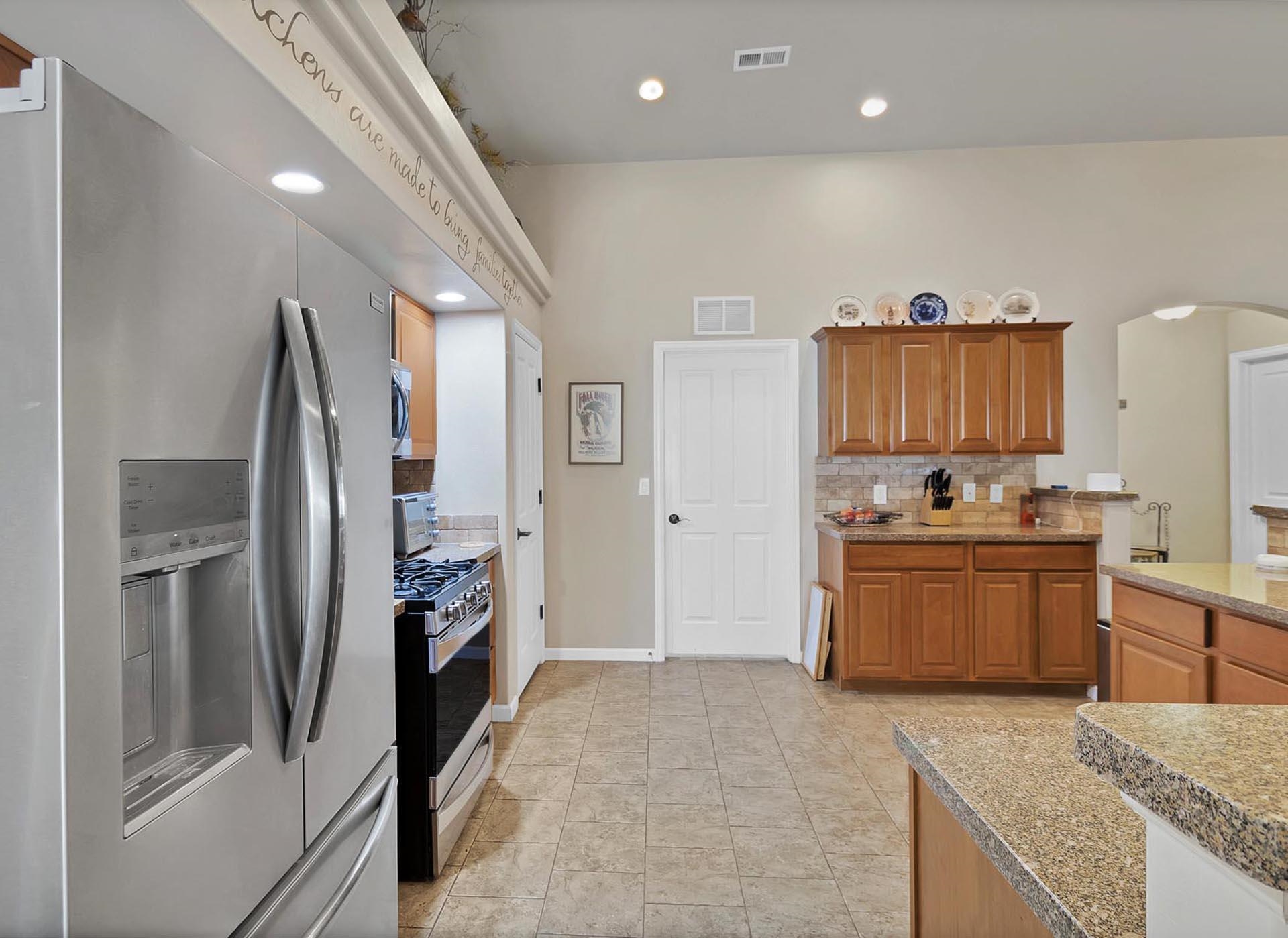 247 Mason Ridge Drive Grand Junction, CO 81503 - Photo 20 of 40 a large kitchen with stainless steel appliances granite countertop a refrigerator and a sink