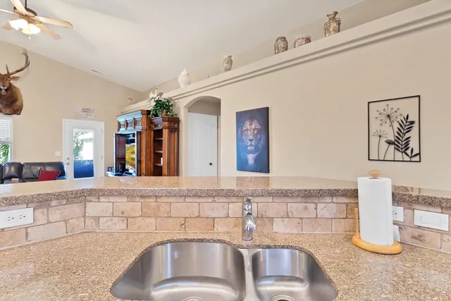 a kitchen with granite countertop stainless steel appliances stove top oven and cabinets