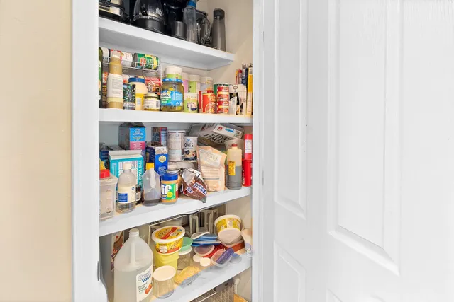 a room with a bed and a mirror on dresser