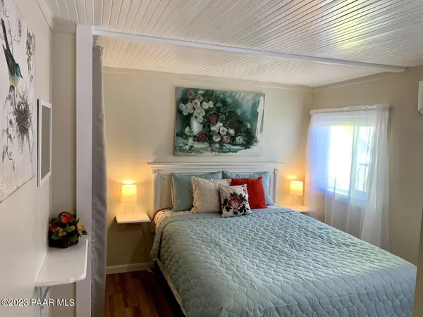 a bedroom with a bed and a potted plant