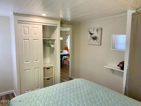 a bedroom with a bed and painting on the wall