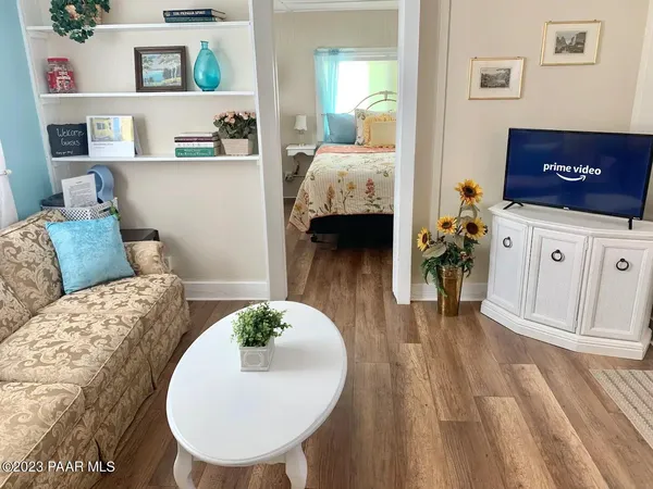 a living room with furniture and a wooden floor