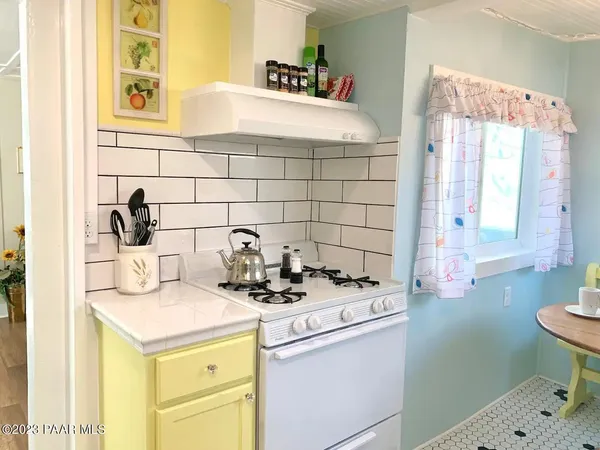 a bathroom with a sink a vanity and a blue shower