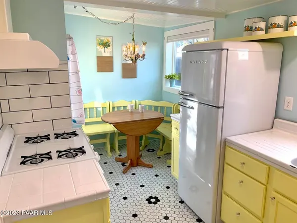 a kitchen with a refrigerator and a stove