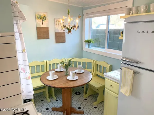 a view of a dining room with furniture and chandelier