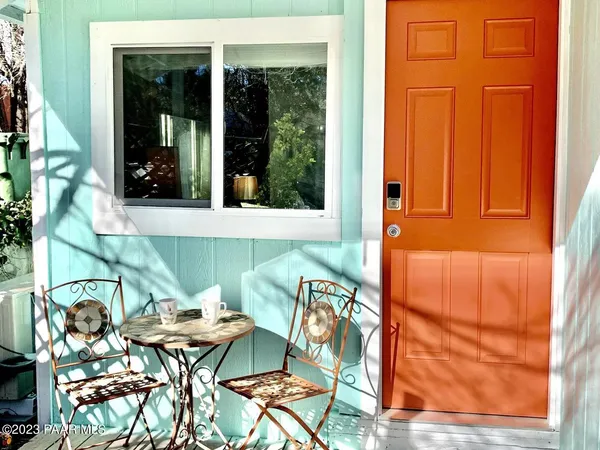 a view of a patio with table and chairs and potted plants