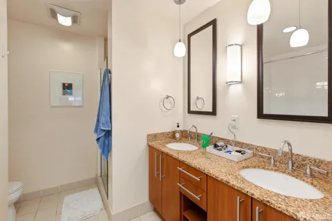 a bathroom with a granite countertop sink and a mirror